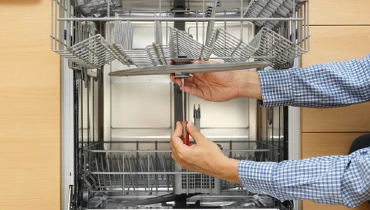 Appliance tech servicing a dishwasher