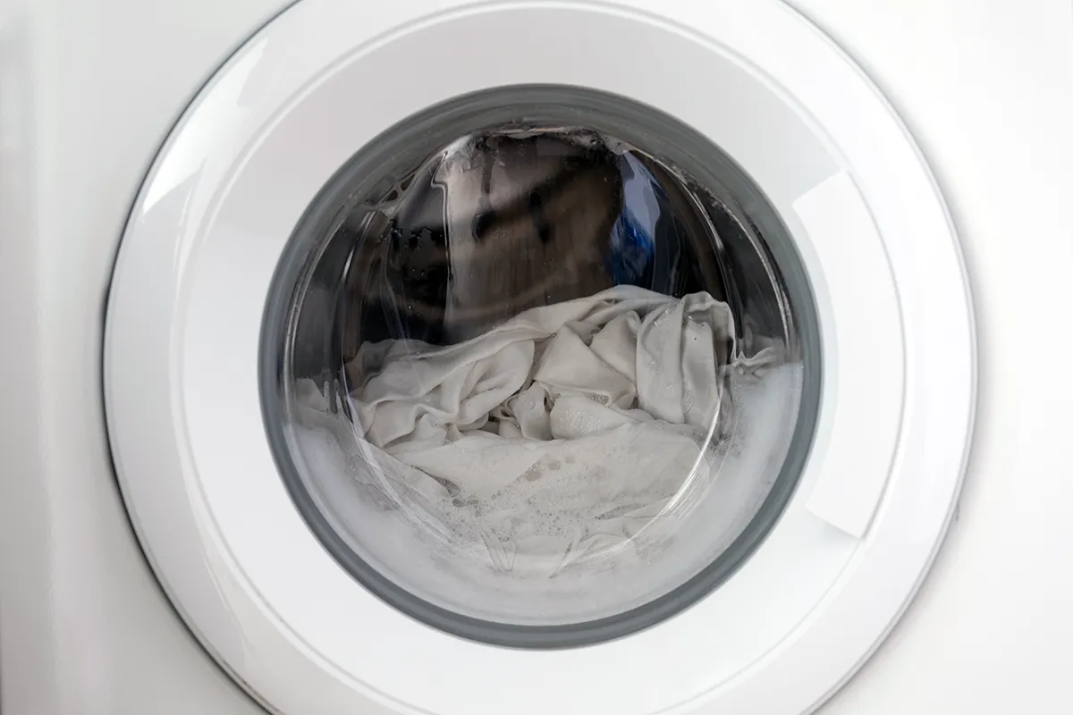 A washing machine full of clothes and water that won’t drain.