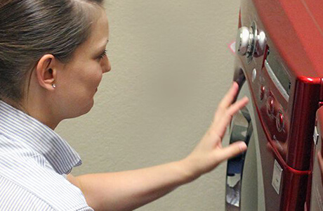 Mr. Appliance tech assessing a front-loading washer