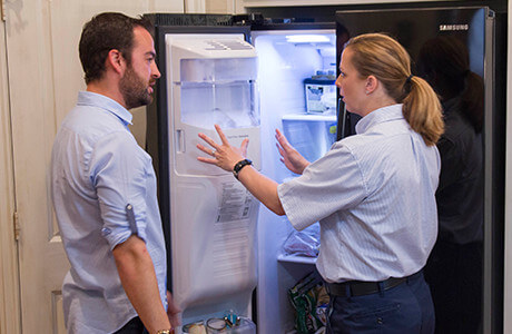 Mr. Appliance tech repairing a refrigerator