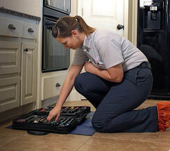 Mr. Appliance technician working on an oven repair 