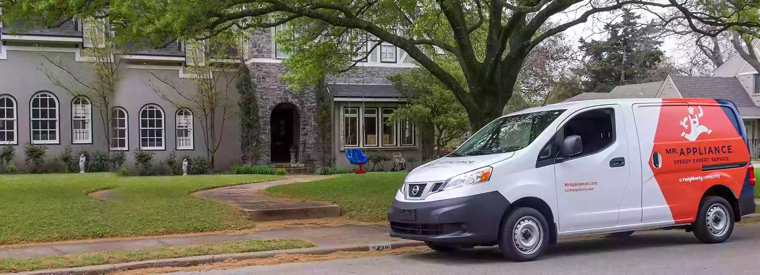 Mr. Appliance branded van parked in front of large gray residential home