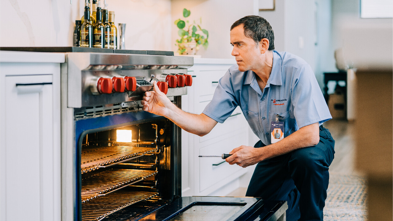 Mr. Appliance tech servicing a high-end range