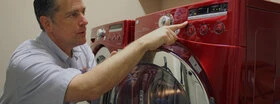 Mr. Appliance tech assessing washer and dryer.