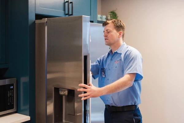 Service professional working on a freezer.