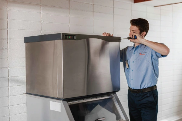 Service professional working on an ice maker.